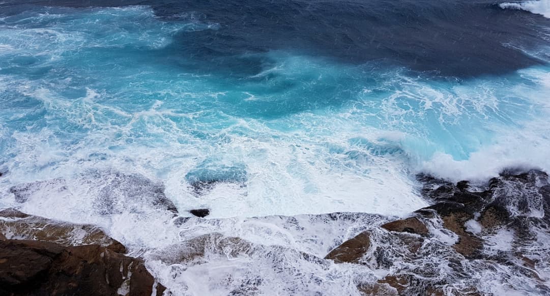 Ocean waves crashing against rocky coastline