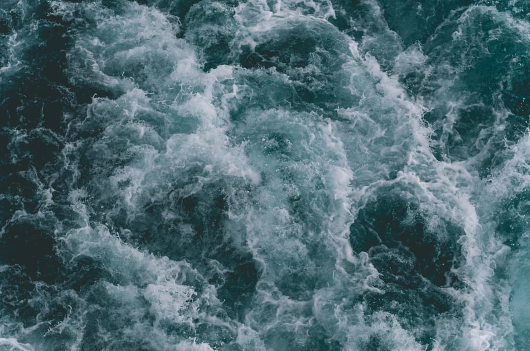 Aerial view of turbulent sea water creating dynamic white patterns