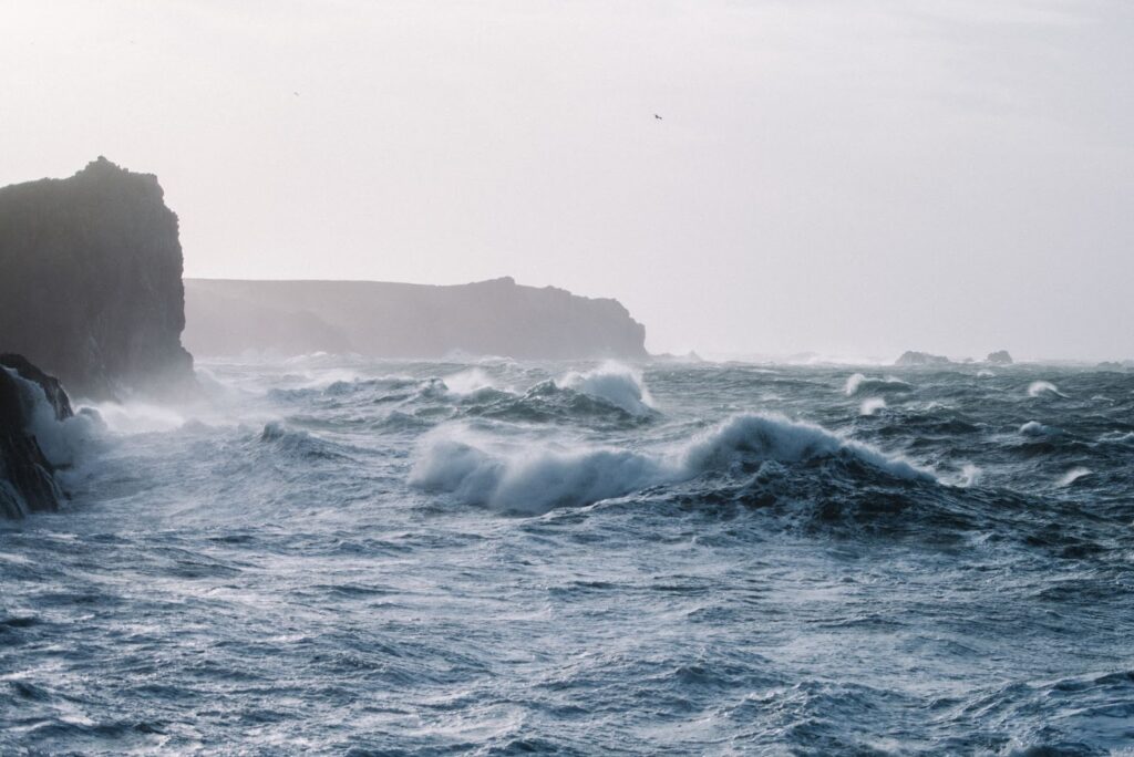 Ocean waves crashing over rock formations